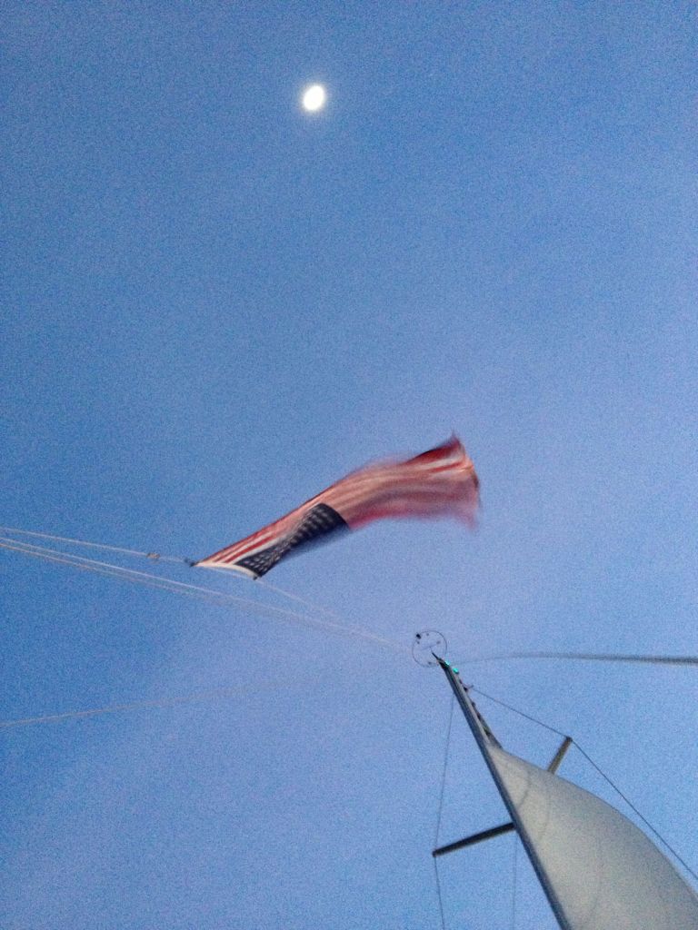 30. Joyful's United States of America ensign flying on her backstay, highlighted by the full moon.
