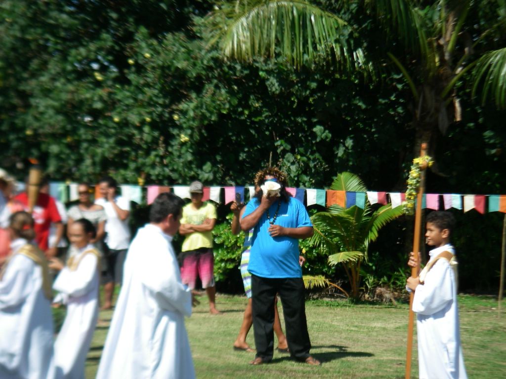 50. The Catholic church held a procession outside near the foot of Mt. Pahia.  A local man played the conch shell to praise the Lord during the procession, as he did at certain times during the church services in the sanctuary.