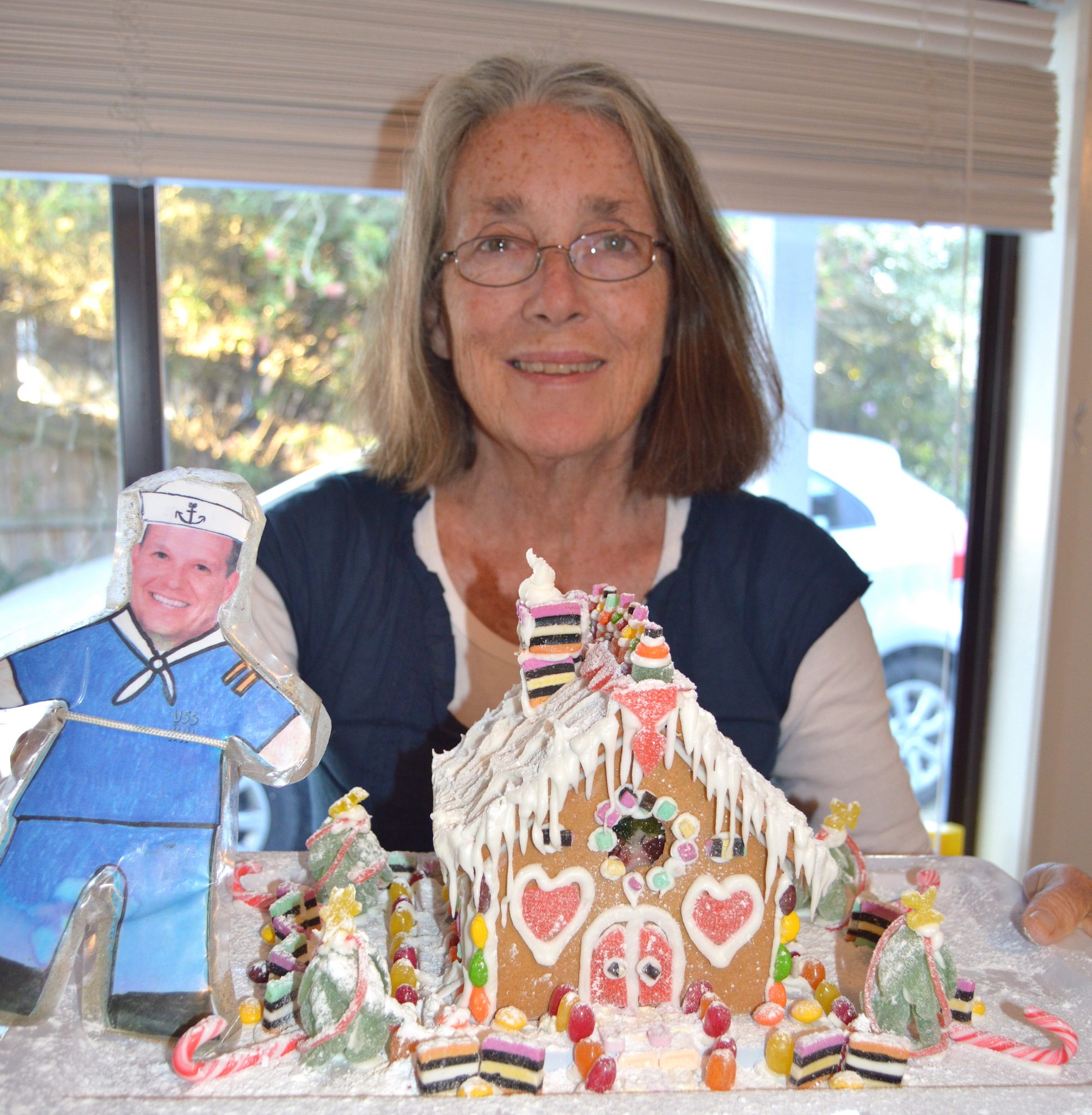 134.1. Flat Mr. Davis and Anne with the gingerbread house they made for residents of an elder care center on Phillip Island, Australia